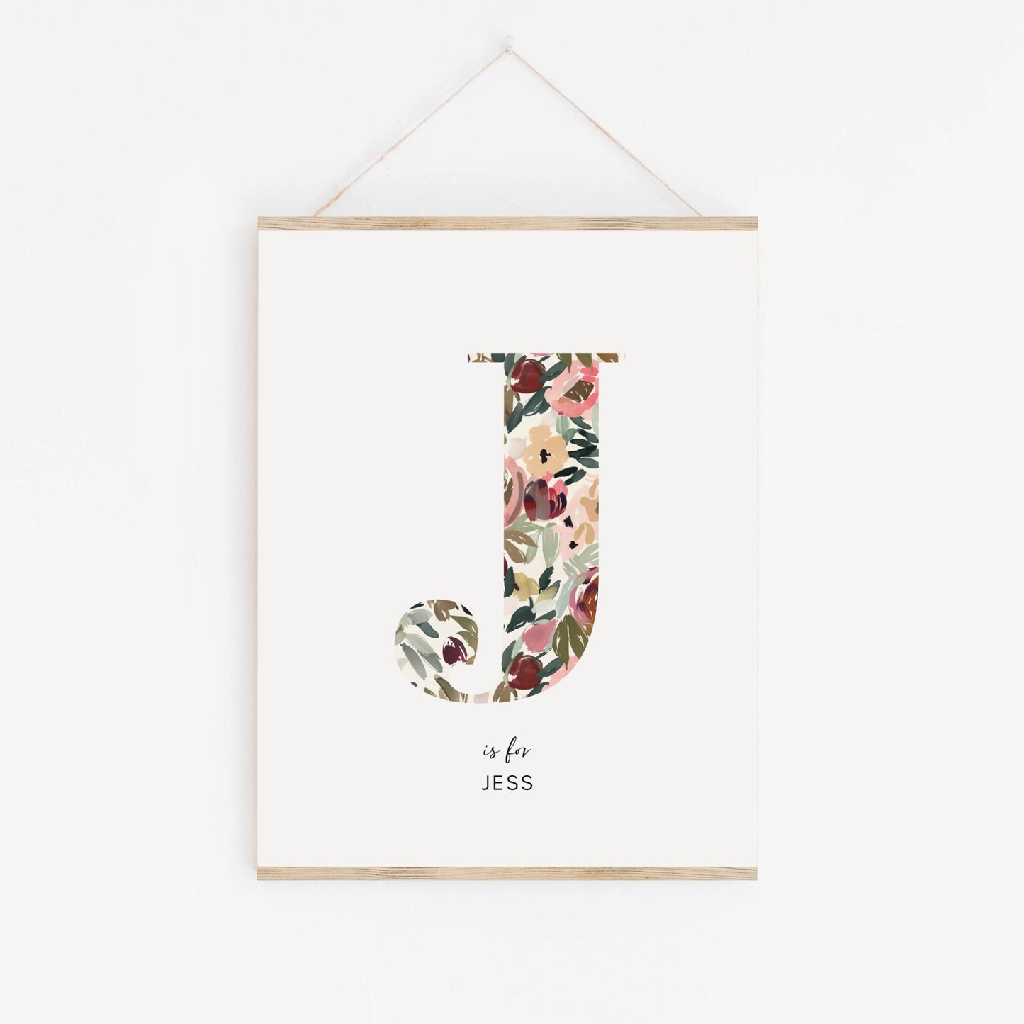 a floral letter is hanging on a wall