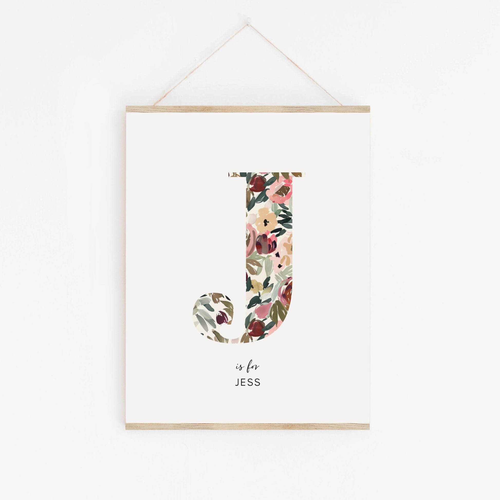 a floral letter is hanging on a wall