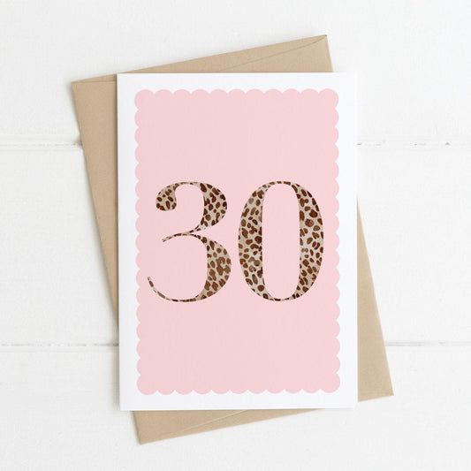 A 30th birthday card with animal print number 30 on a pastel pink background, with a kraft brown envelope