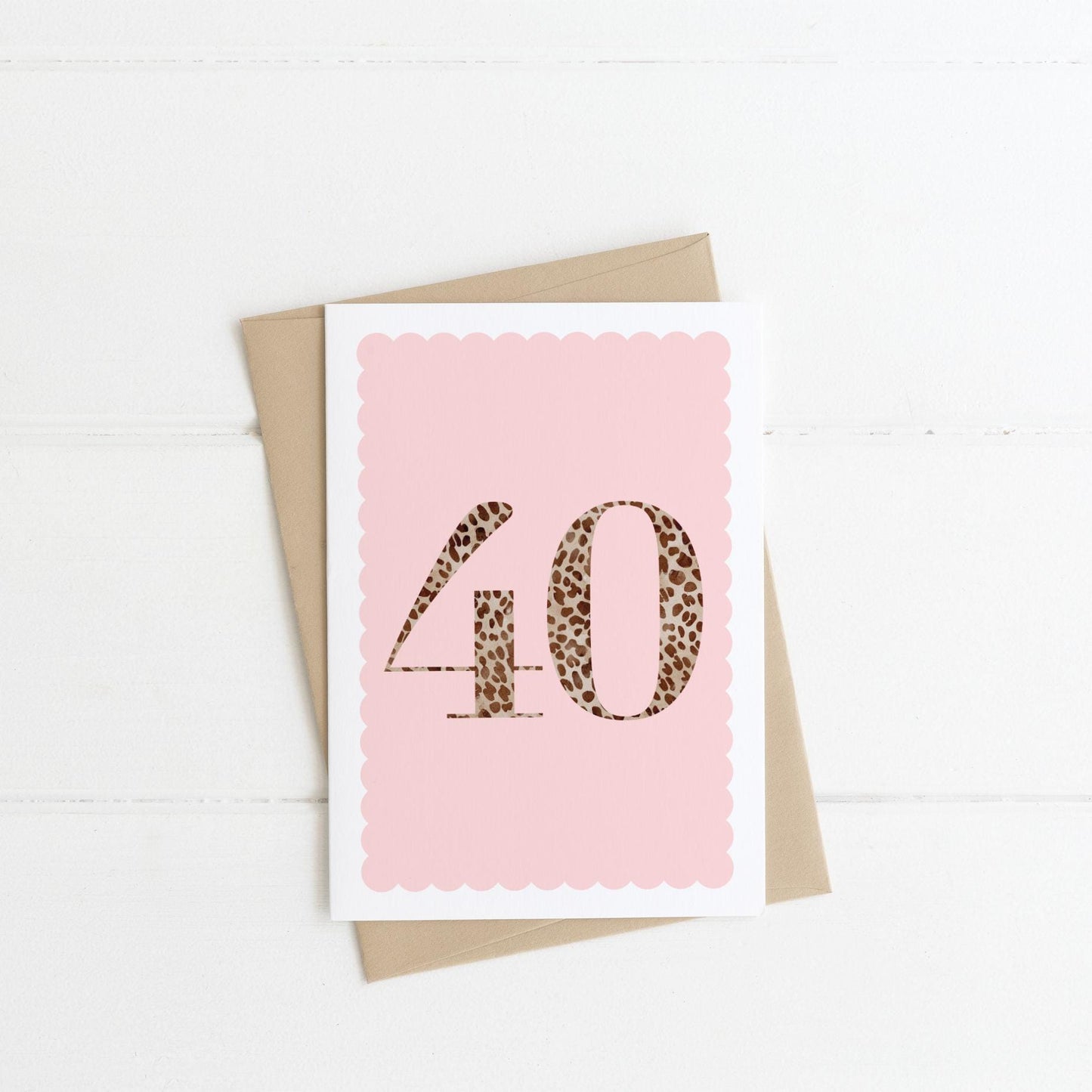 A 40th birthday card with animal print number 40 on a blush pink background, with a kraft brown envelope