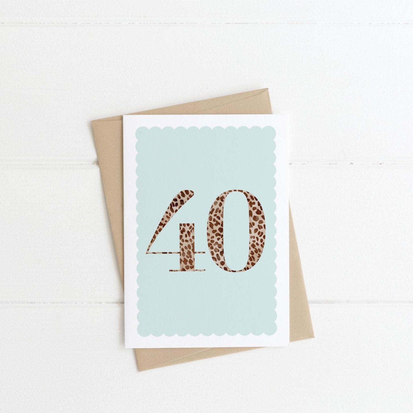A 40th birthday card with animal print number 40 on a pastel blue background, with a kraft brown envelope