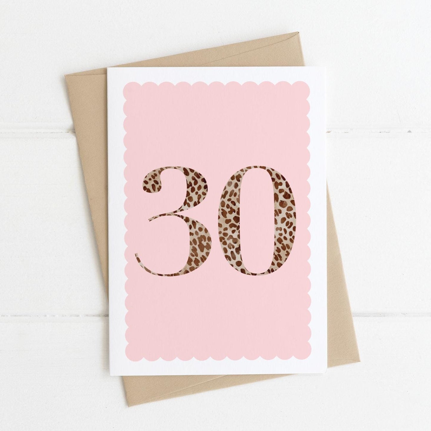 A 30th birthday card with animal print number 30 on a pastel pink background, with a kraft brown envelope