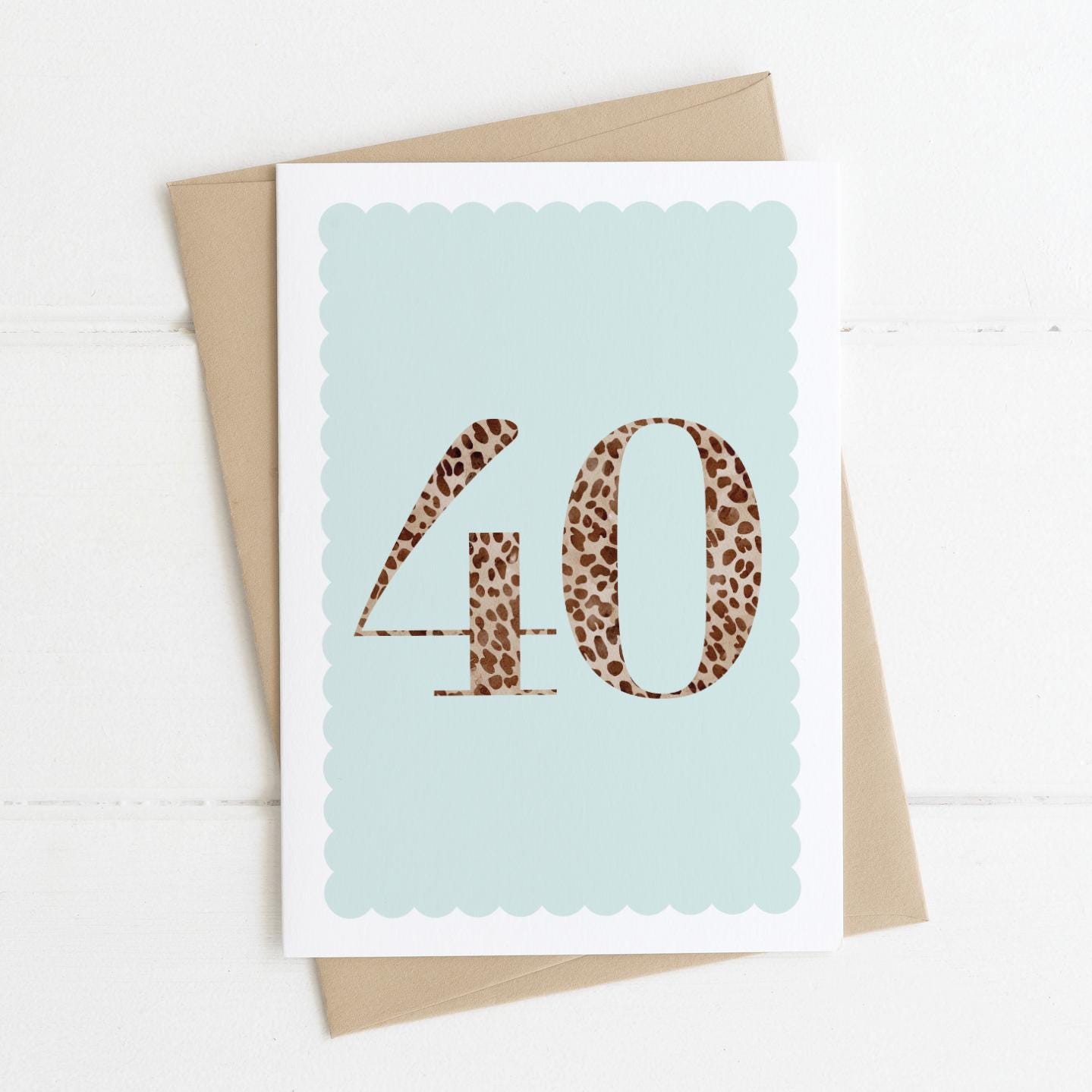 A 40th birthday card with animal print number 40 on a pastel blue background, with a kraft brown envelope