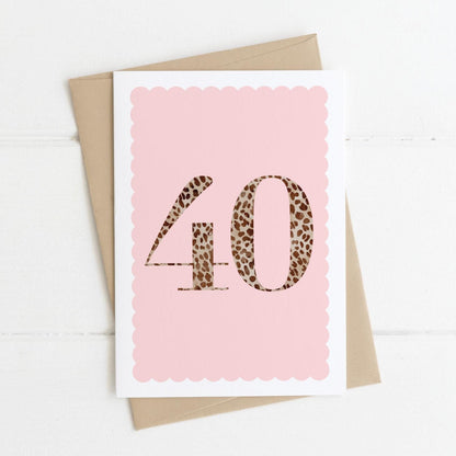 A 40th birthday card with animal print number 40 on a blush pink background, with a kraft brown envelope