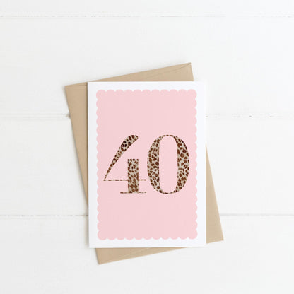 A 40th birthday card with animal print number 40 on a blush pink background, with a kraft brown envelope